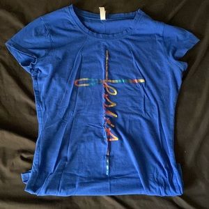 Blue shirt with multi color word spelling Jesus